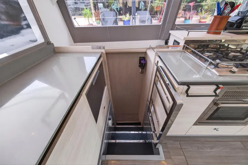 Slide: The Image of Modern kitchen interior on a 2021 Leopard 50 yacht, featuring sleek countertops and a gas stove. - 58