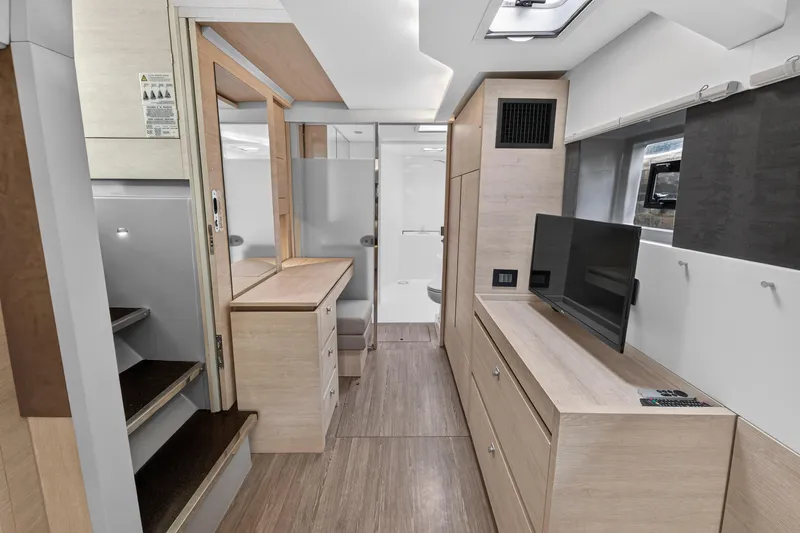 Slide: The Image of Modern interior of 2021 Leopard 50 yacht with sleek wood finishes and built-in TV. - 63