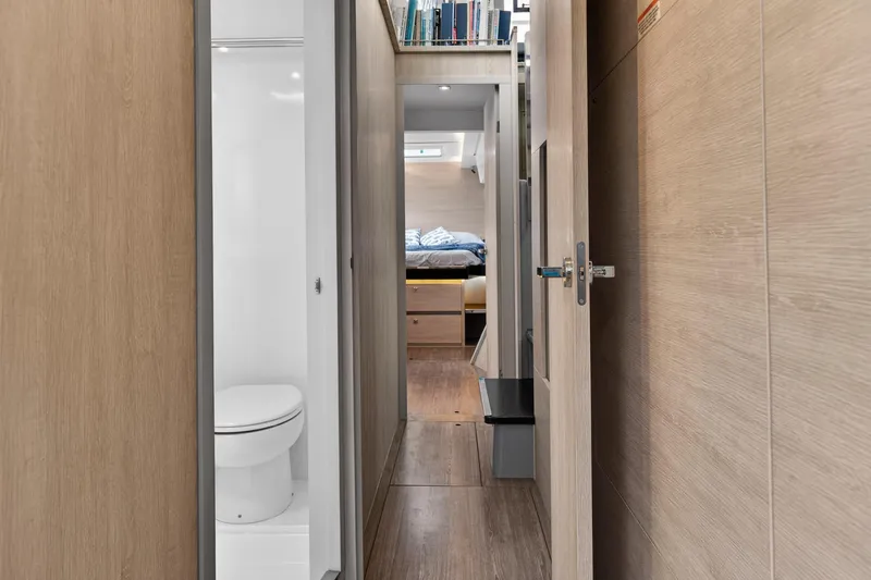 Slide: The Image of Interior of 2021 Leopard 50 yacht featuring hallway, bathroom, and bedroom. - 89