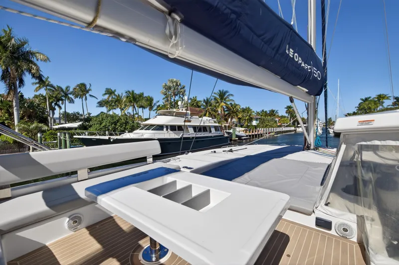 Slide: The Image of Leopard 50 yacht interior, 2022 model, featuring sleek seating and modern design by the water. - 14