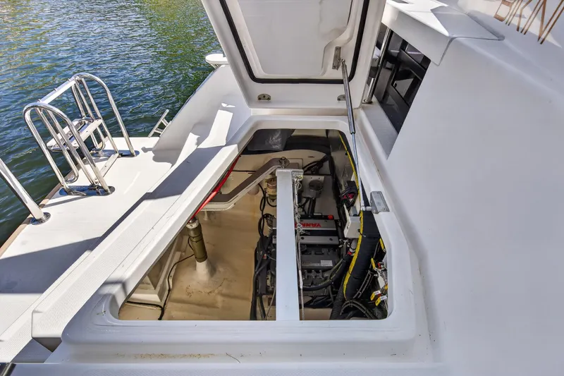 Slide: The Image of Engine compartment of a 2022 Leopard 50 yacht, open hatch, visible machinery. - 146