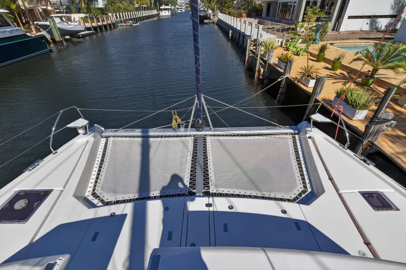 Slide: The Image of Luxurious 2022 Leopard 50 yacht interior with modern seating and table, docked near waterfront homes. - 17