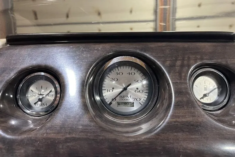 Slide: The Image of Dashboard gauges of a 2018 Bennington 23 SLX boat, showing RPM, trim, and fuel levels. - 12