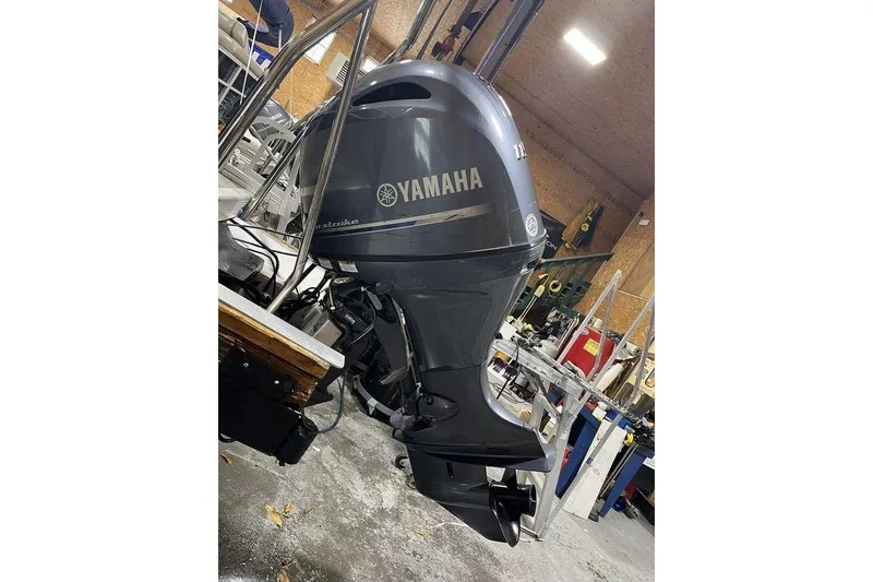 Slide: The Image of Yamaha outboard motor on 2018 Bennington 23 SLX boat in a workshop setting. - 16