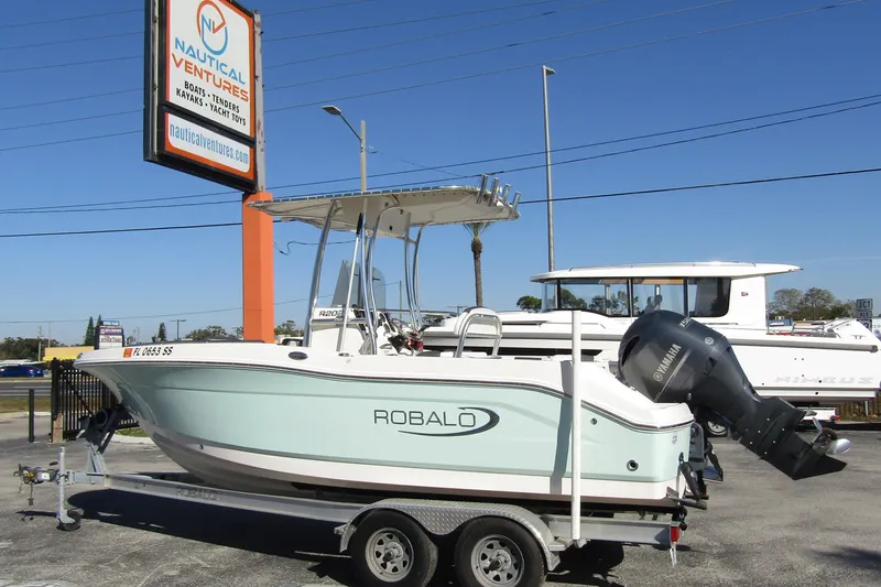 Slide: The Image of 2019 Robalo R202 Explorer boat on trailer at Nautical Ventures dealership. - 1