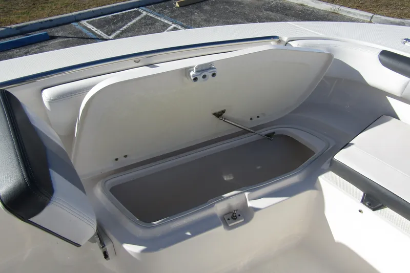 Slide: The Image of 2019 Robalo R202 Explorer boat storage compartment open, showcasing interior space. - 11
