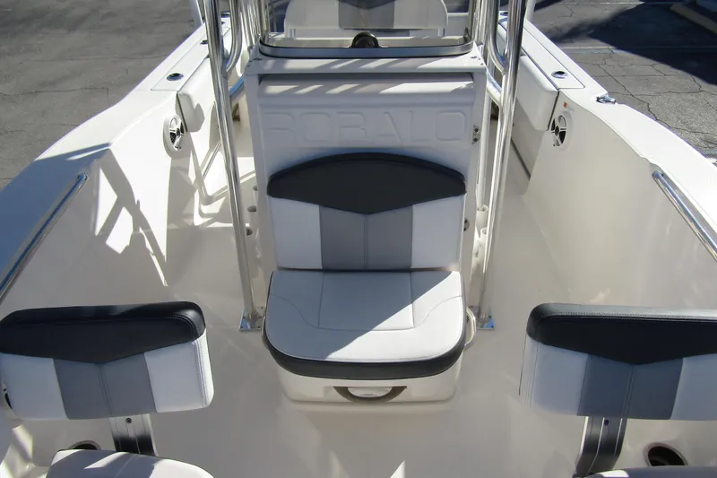 Slide: The Image of 2019 Robalo R202 Explorer boat interior with cushioned seating and sleek design. - 12