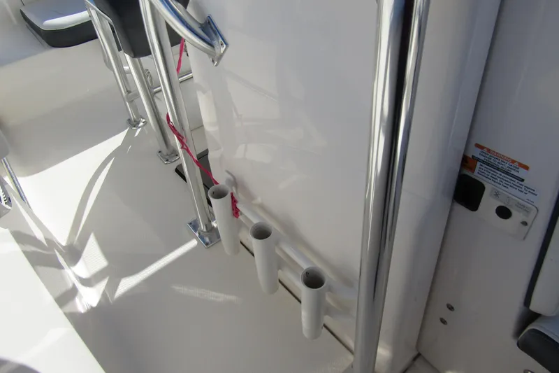 Slide: The Image of 2019 Robalo R202 Explorer boat interior with rod holders and stainless steel railing. - 15