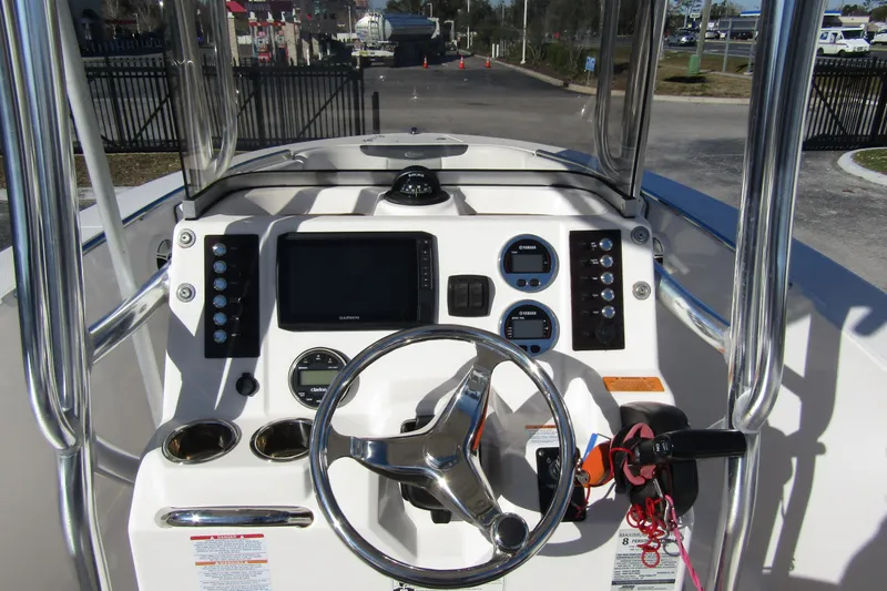 Slide: The Image of 2019 Robalo R202 Explorer boat dashboard with steering wheel and navigation controls. - 17