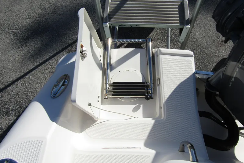 Slide: The Image of 2019 Robalo R202 Explorer boat with foldable swim ladder and deck details. - 28