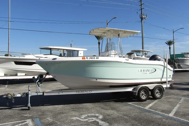 Slide: The Image of 2019 Robalo R202 Explorer boat on trailer in parking lot, clear sky background. - 6