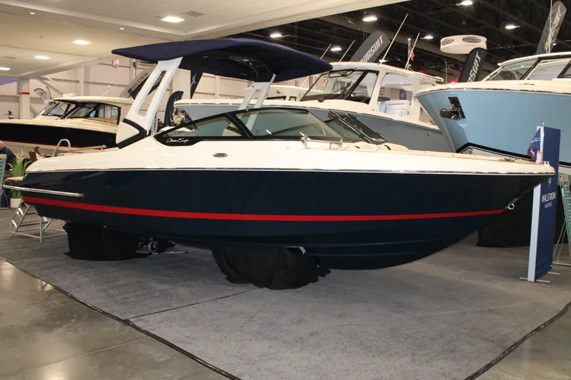 The Image of 2026 Chris-Craft Sportster 25 boat displayed indoors at a boat show. - 15