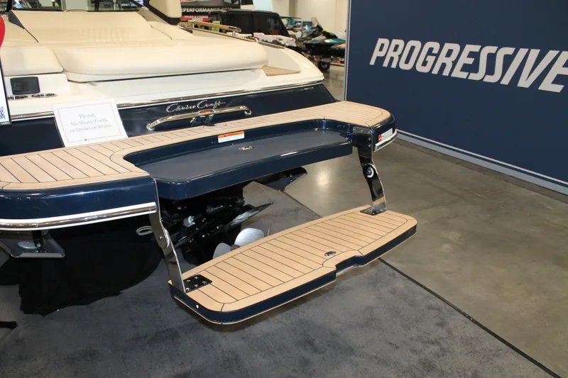 Slide: The Image of 2026 Chris-Craft Sportster 25 boat with elegant swim platform at a boat show. - 18