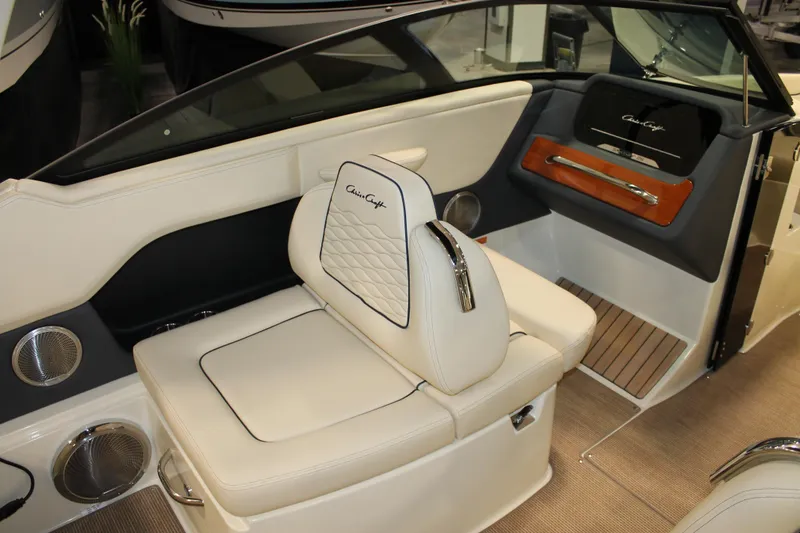 Slide: The Image of 2026 Chris-Craft Sportster 25 interior with luxurious white seating and elegant dashboard design. - 32