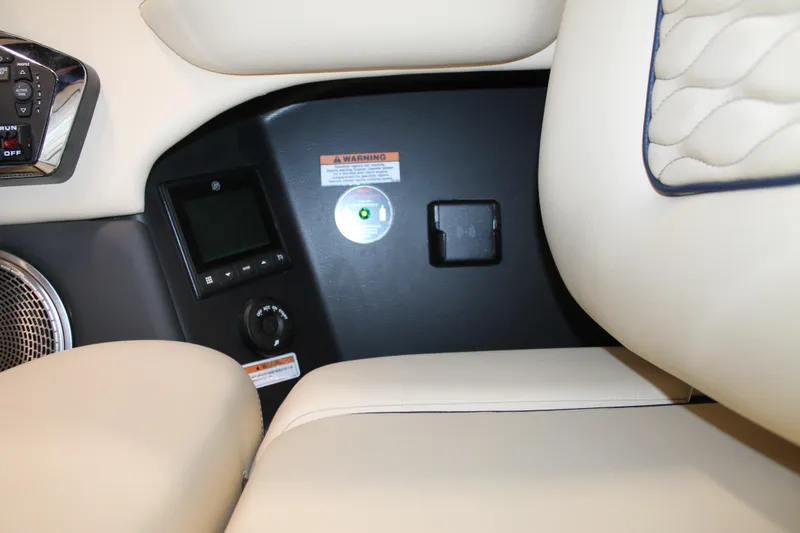 Slide: The Image of 2026 Chris-Craft Sportster 25 interior dashboard with controls and beige seating. - 34