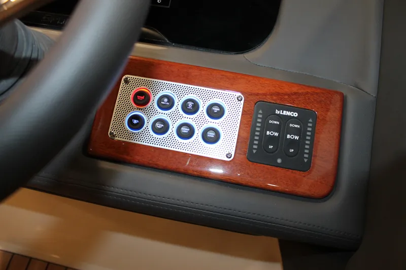Slide: The Image of Control panel of 2026 Chris-Craft Sportster 25 with wood trim and Lenco switches. - 36
