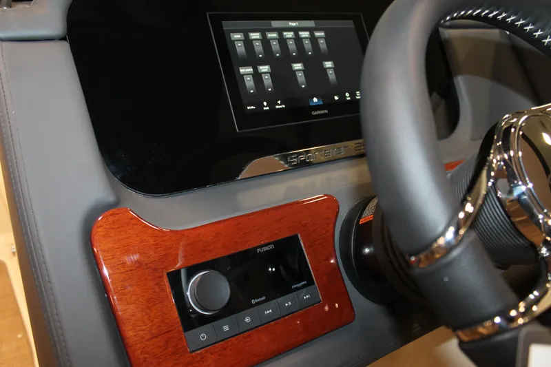Slide: The Image of 2026 Chris-Craft Sportster 25 dashboard with touchscreen and steering wheel. - 37