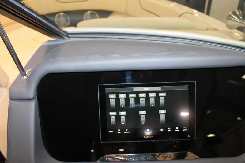 Slide: The Image of 2026 Chris-Craft Sportster 25 dashboard with Garmin touchscreen display. - 38
