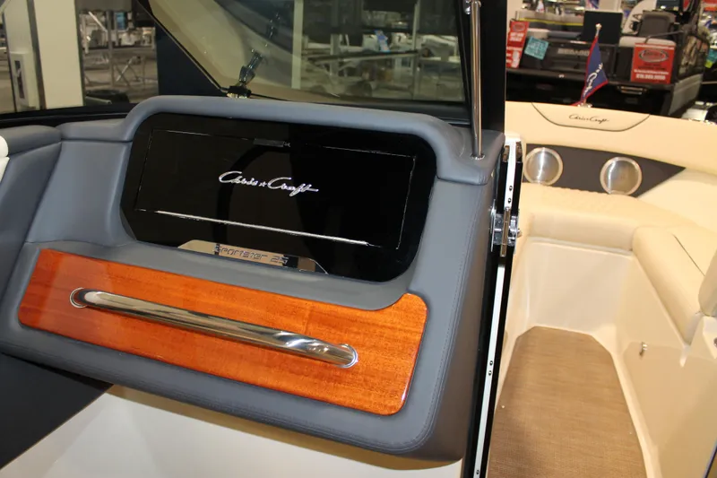 Slide: The Image of 2026 Chris-Craft Sportster 25 interior with elegant wood and leather detailing. - 39