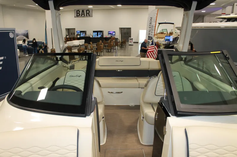 Slide: The Image of 2026 Chris-Craft Sportster 25 boat interior at an indoor exhibition, featuring luxurious seating. - 41