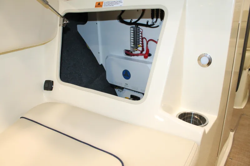 Slide: The Image of Interior view of 2026 Chris-Craft Sportster 25, showcasing storage compartment and seating area. - 42