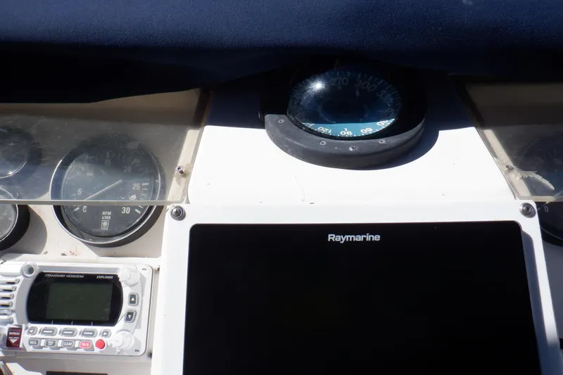 Slide: The Image of Marine Trader 47 Tradewinds 1990 dashboard with Raymarine display and navigation instruments. - 13