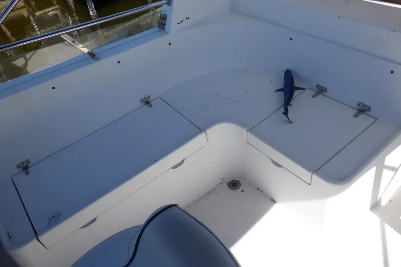 Slide: The Image of 1990 Marine Trader 47 Tradewinds boat deck with storage compartments and toy shark. - 16