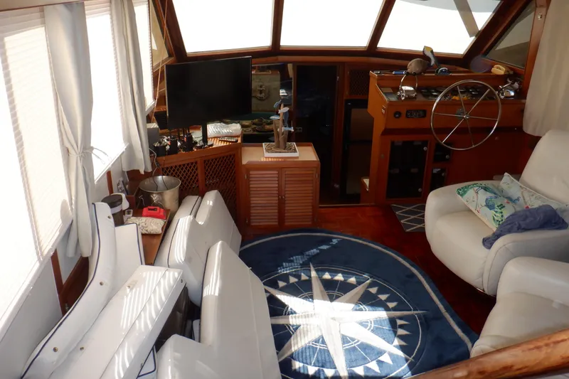 Slide: The Image of Interior of 1990 Marine Trader 47 Tradewinds yacht with helm, seating, and nautical decor. - 17