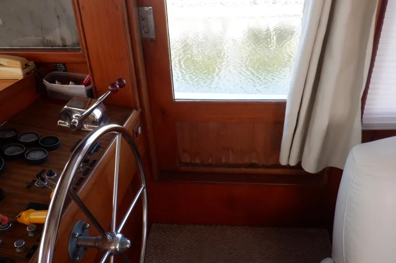 Slide: The Image of Interior helm of 1990 Marine Trader 47 Tradewinds yacht with steering wheel and controls. - 23
