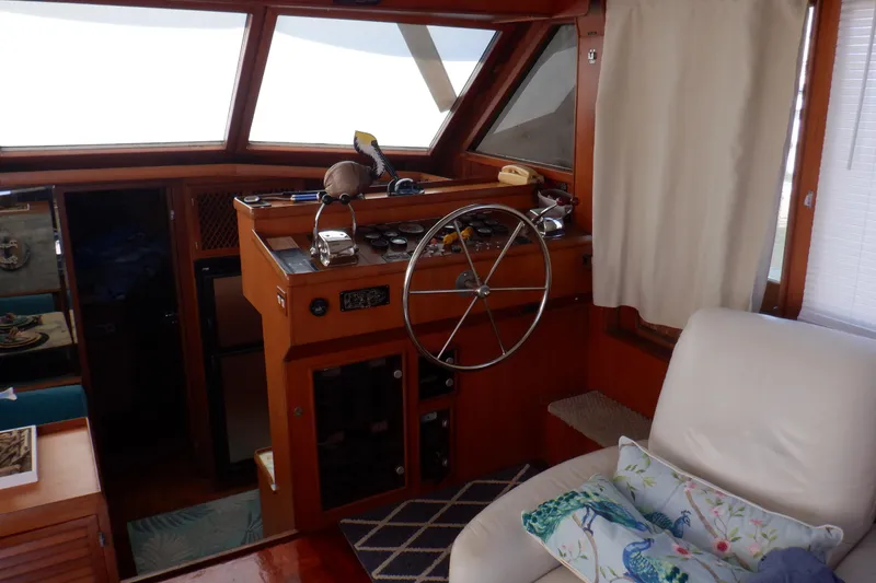 Slide: The Image of Interior of 1990 Marine Trader 47 Tradewinds yacht with helm and seating area. - 24