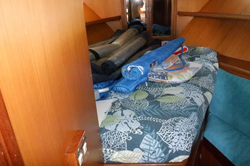 Slide: The Image of Cozy cabin interior of 1990 Marine Trader 47 Tradewinds with patterned bedding and storage. - 35