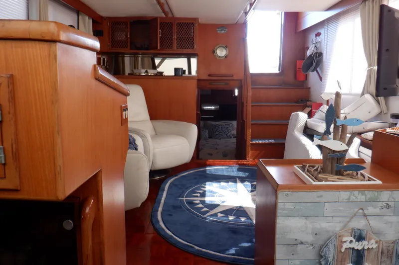 Slide: The Image of Interior of 1990 Marine Trader 47 Tradewinds yacht with cozy seating and nautical decor. - 37