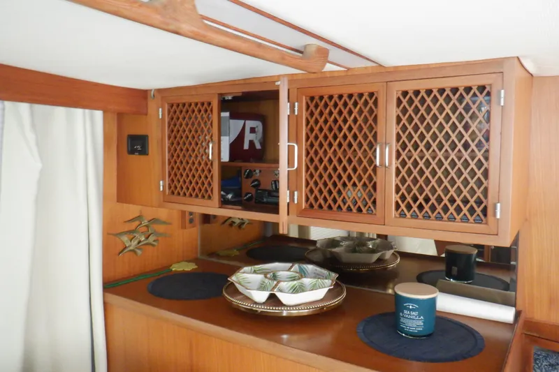Slide: The Image of Interior of 1990 Marine Trader 47 Tradewinds with wooden cabinets and decorative items. - 39