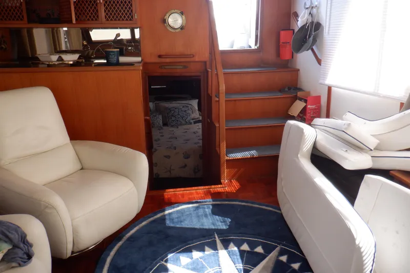 Slide: The Image of Interior of 1990 Marine Trader 47 Tradewinds yacht with cozy seating and nautical decor. - 40