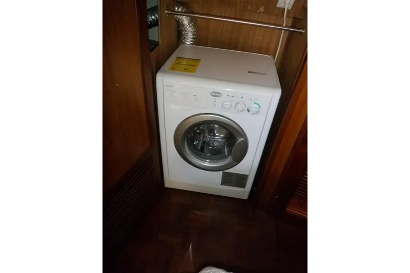 Slide: The Image of Washing machine inside 1990 Marine Trader 47 Tradewinds yacht, wooden interior. - 44