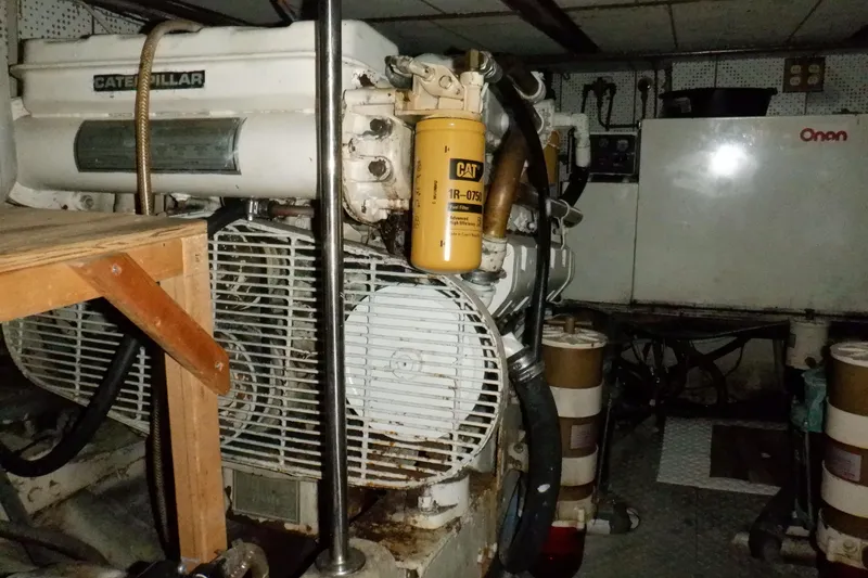 Slide: The Image of Engine room of 1990 Marine Trader 47 Tradewinds with Caterpillar engine and Onan generator. - 49
