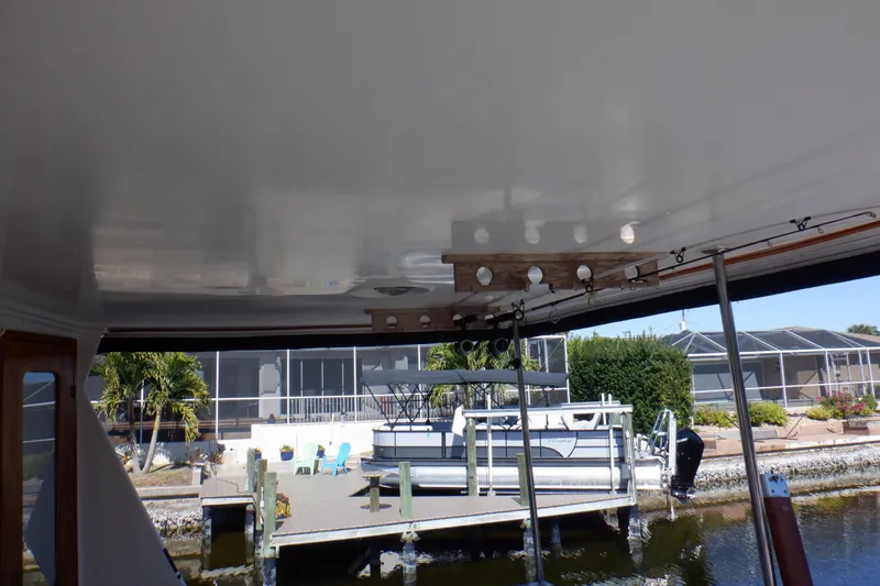 Slide: The Image of 1990 Marine Trader 47 Tradewinds yacht docked near waterfront property. - 8