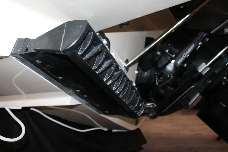 Slide: The Image of 2026 Chris-Craft Launch 28 GT boat detail, featuring a close-up of the trim tab and engine. - 21