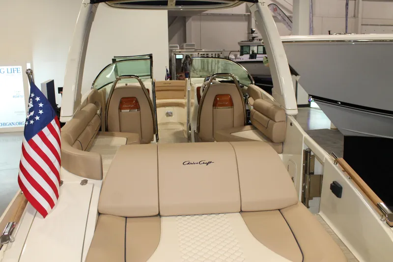 Slide: The Image of 2026 Chris-Craft Launch 28 GT boat interior with American flag, showcasing luxury seating. - 23
