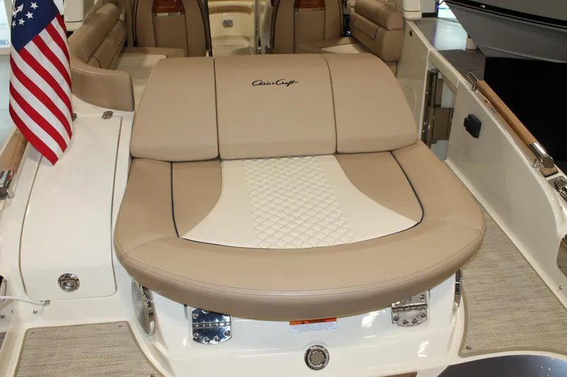 Slide: The Image of 2026 Chris-Craft Launch 28 GT boat interior with beige seating and American flag. - 24