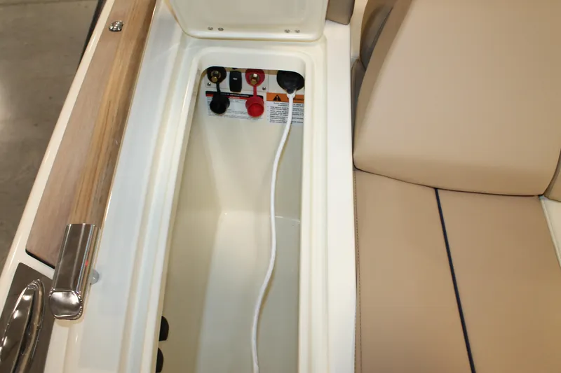 Slide: The Image of 2026 Chris-Craft Launch 28 GT storage compartment with beige seating and control panel. - 25