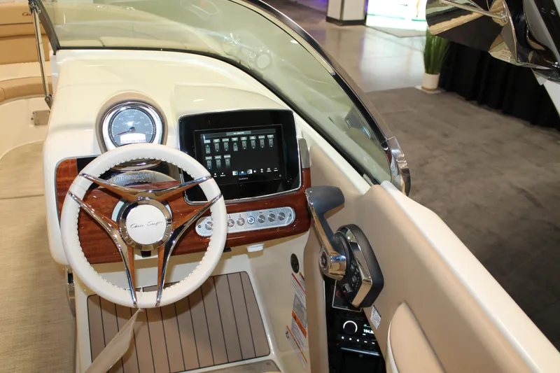 Slide: The Image of 2026 Chris-Craft Launch 28 GT dashboard with steering wheel and digital display. - 33