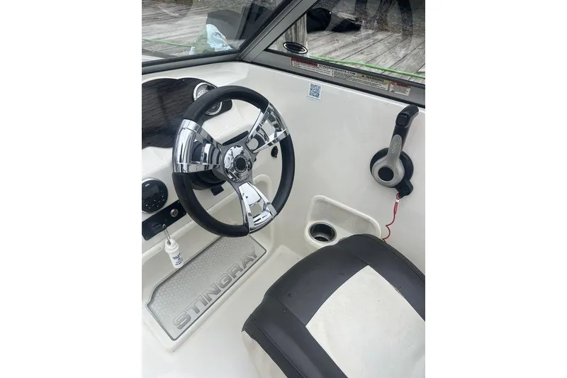 Slide: The Image of 2017 Stingray 191 DC boat interior with steering wheel and controls. - 5