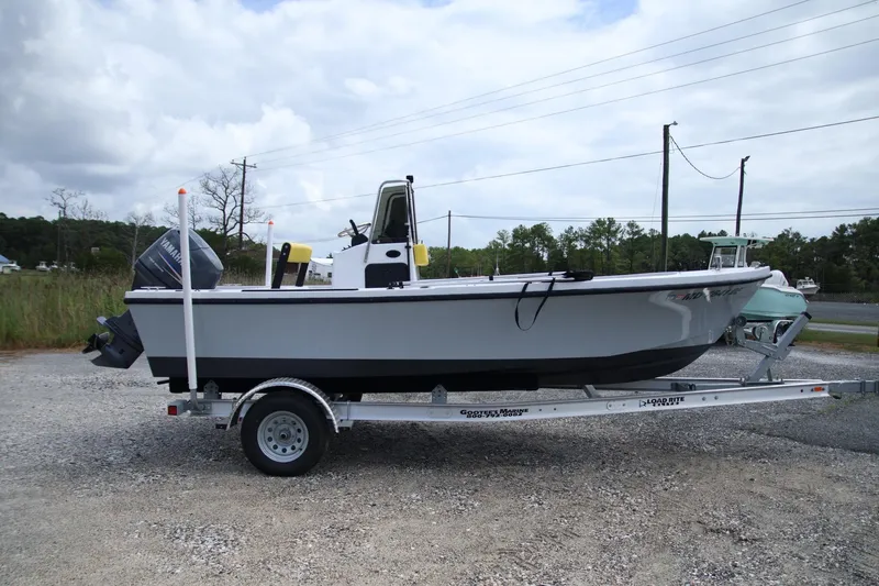 The Image of 1988 Parker 1801 Center Console boat on trailer, side view, outdoors. - 0