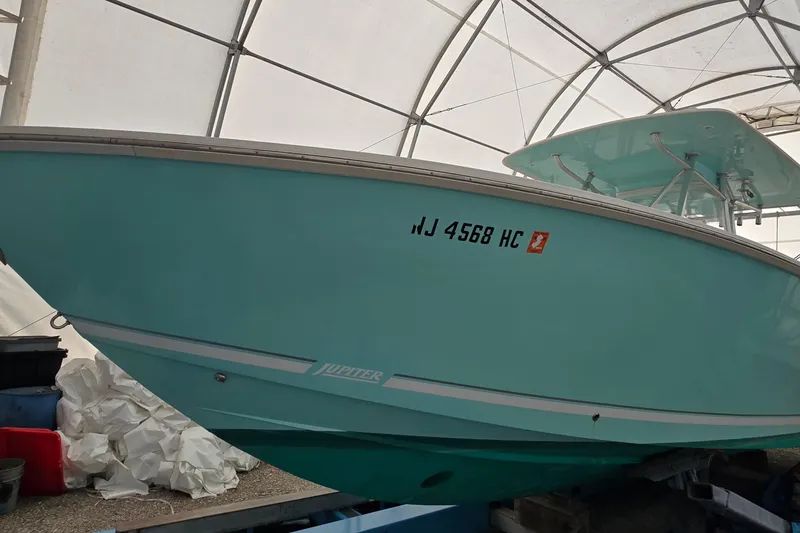 Slide: The Image of 2010 Jupiter 34 FS boat in storage, displaying registration number NJ 4568 HC. - 1