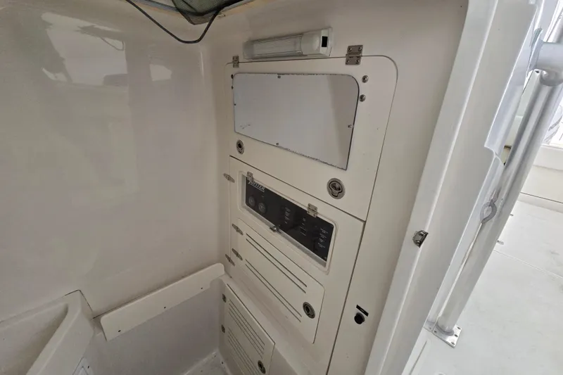 Slide: The Image of Control panel inside a 2010 Jupiter 34 FS boat, featuring various switches and compartments. - 14