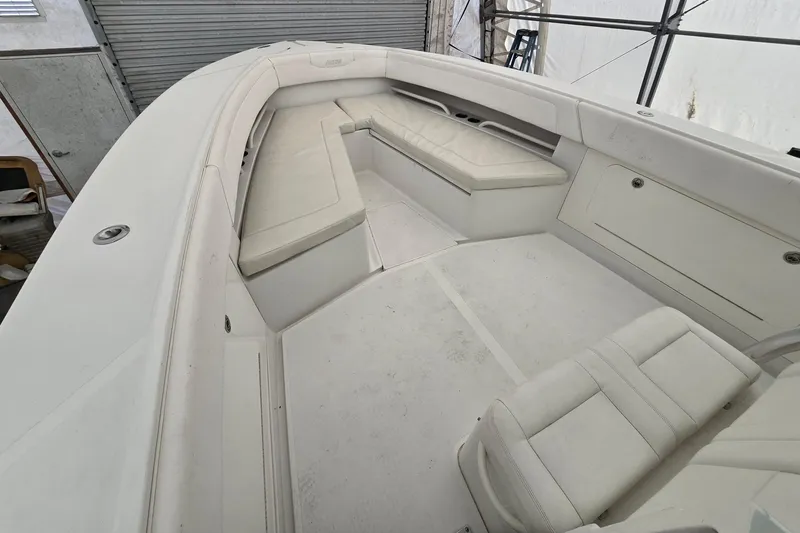 Slide: The Image of 2010 Jupiter 34 FS boat interior with white seating and storage compartments. - 16