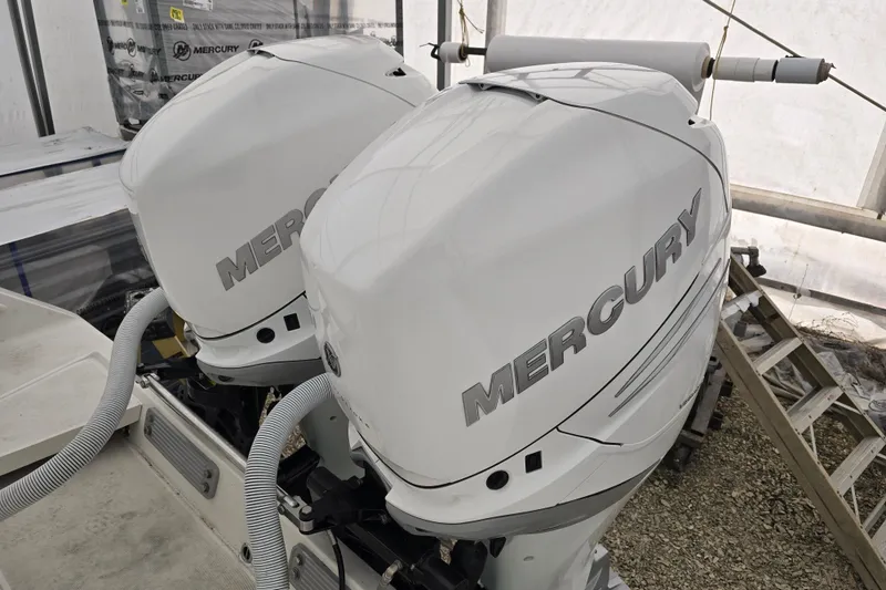 Slide: The Image of Twin Mercury outboard engines on a 2010 Jupiter 34 FS boat. - 24