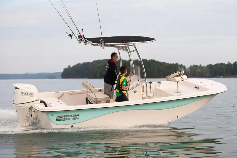 Slide: The Image of Manufacturer Provided Image: 2026 Carolina Skiff 19 LS boat cruising on a lake with two passengers. - 2