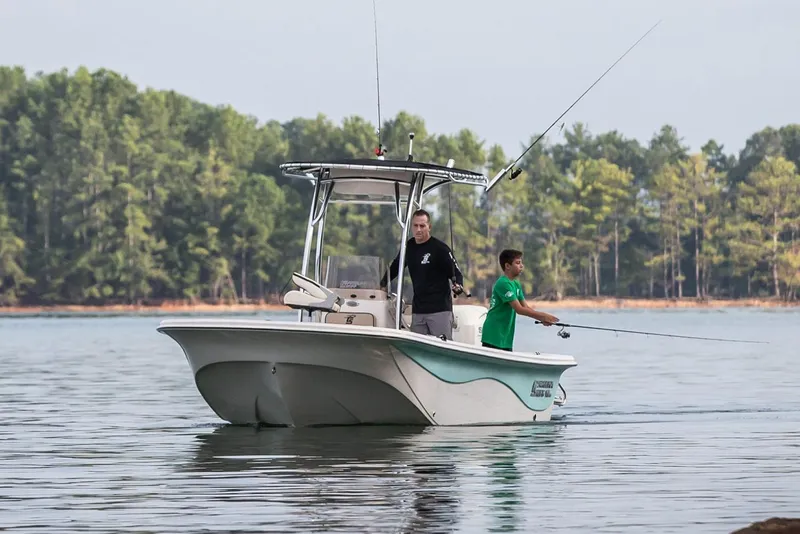 Slide: The Image of Manufacturer Provided Image: 2026 Carolina Skiff 19 LS boat with two people fishing on a calm lake. - 3
